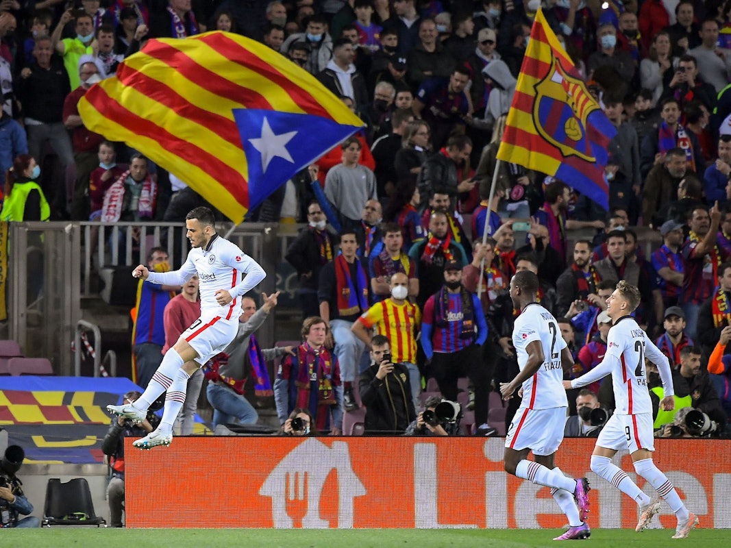 Eintracht Frankfurt's Serbian midfielder Filip Kostic (L) celebrates after scoring his team's first goal during the Europa League quarter final second leg football match between FC Barcelona and Eintracht Frankfurt at the Camp Nou stadium in Barcelona on April 14, 2022. (Photo by Jose Jordan / AFP)