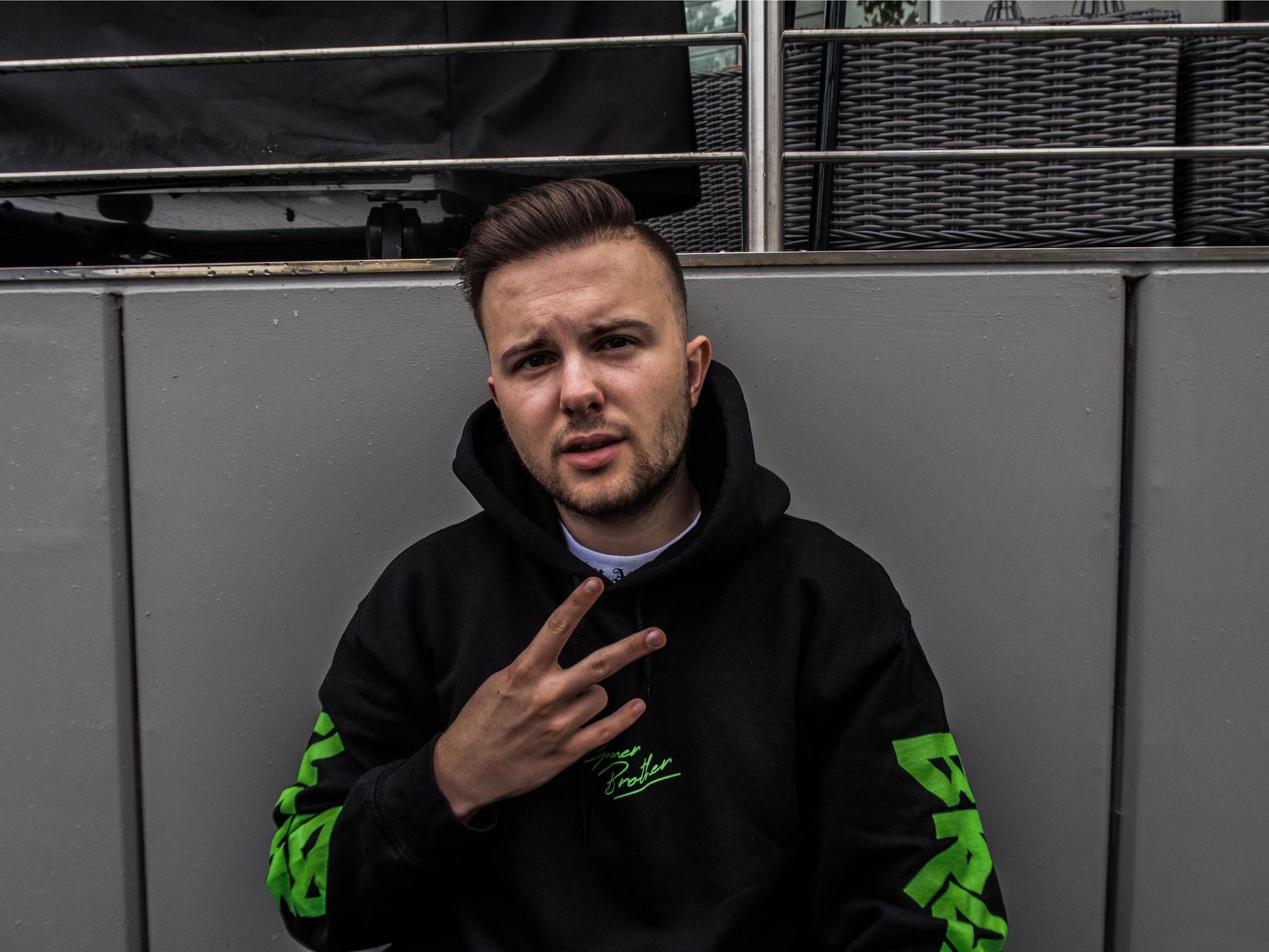 YouTuber Simon Schildgen hält zwei Finger zu einem Peace-Zeichen in die Kamera.