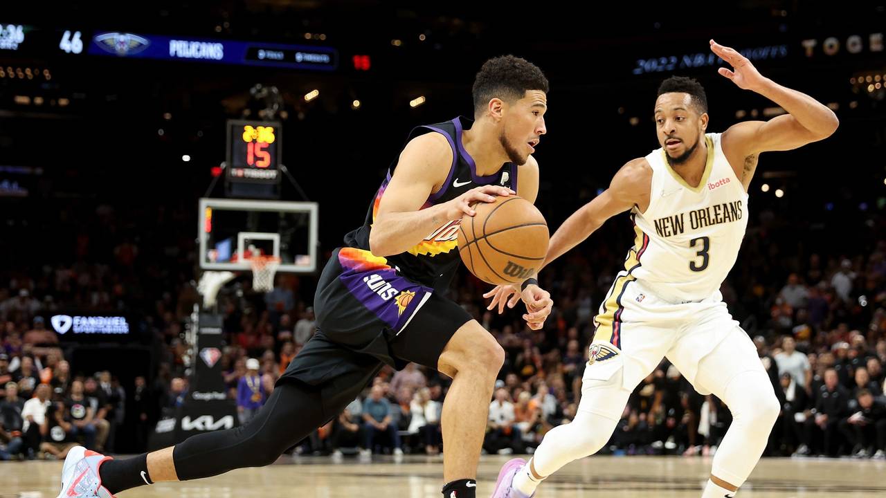 Devin Booker von den Phoenix Suns (links) zieht an CJ McCollum von den New Orleans Pelicans vorbei.