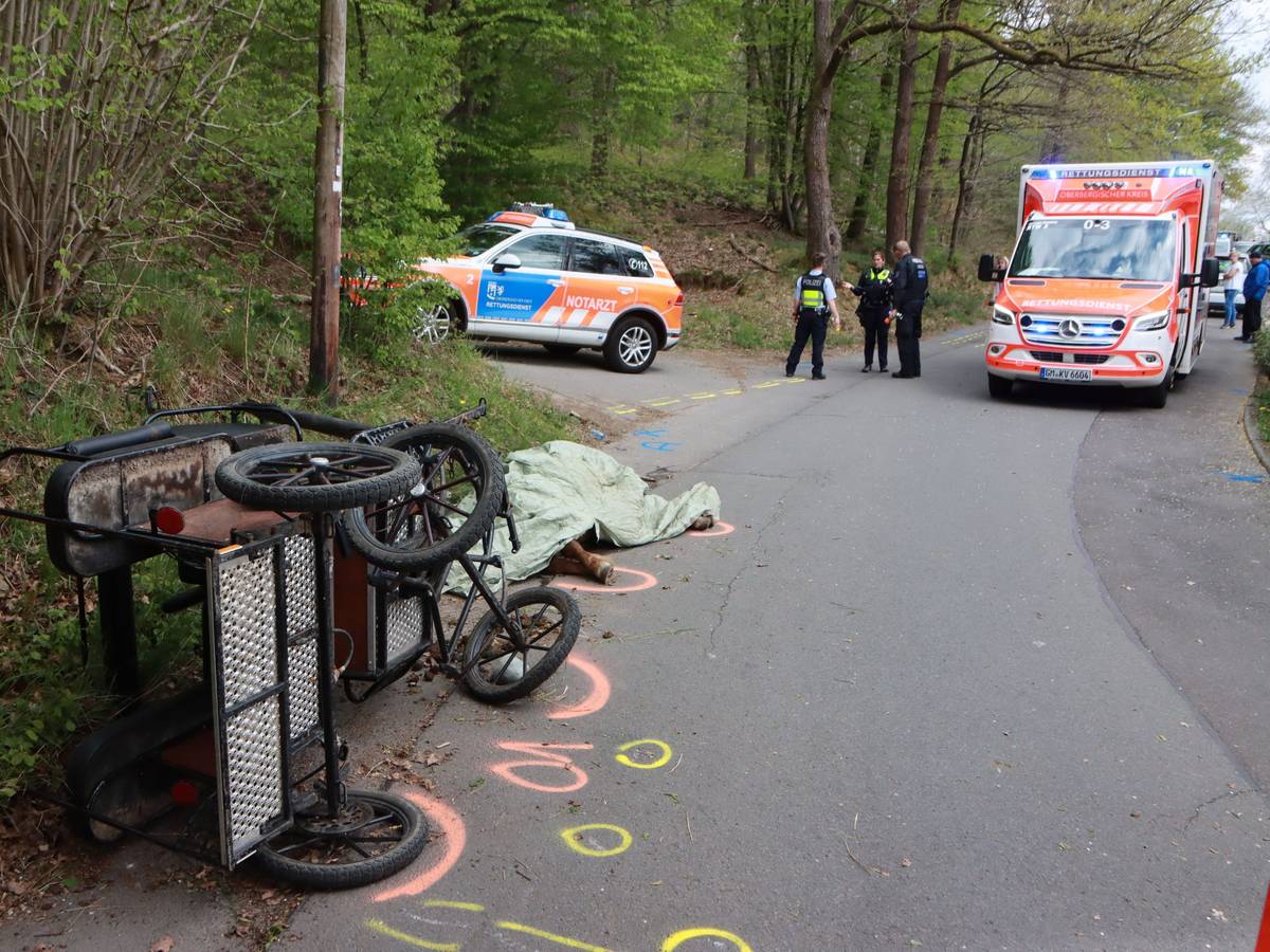 22.04.2022, Nordrhein-Westfalen, Wiehl: Nach dem Sturz einer Kutsche hat die Polizei die Unfallstelle markiert. Bei dem Unfall wurde ein Mädchen lebensgefährlich verletzt. Ein Pferd starb. Foto: Berthold Stamm/dpa +++ dpa-Bildfunk +++