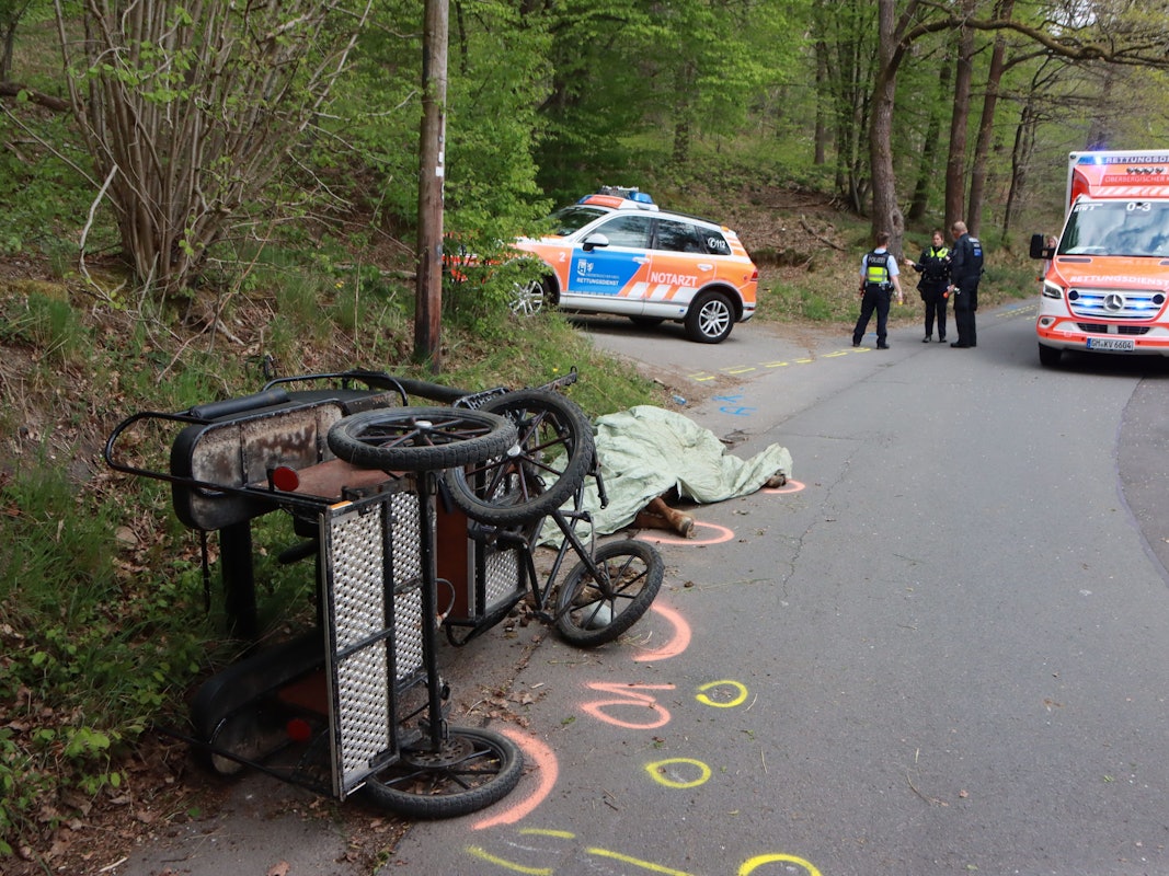 22.04.2022, Nordrhein-Westfalen, Wiehl: Nach dem Sturz einer Kutsche hat die Polizei die Unfallstelle markiert. Bei dem Unfall wurde ein Mädchen lebensgefährlich verletzt. Ein Pferd starb. Foto: Berthold Stamm/dpa +++ dpa-Bildfunk +++