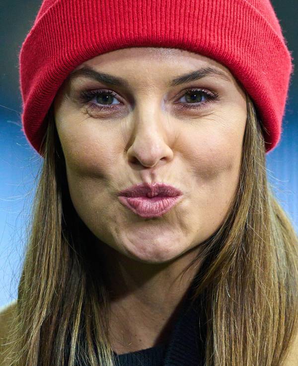 Laura Wontorra formt bei einem Bundesliga-Spiel einen Kuss-Mund in die Kamera.