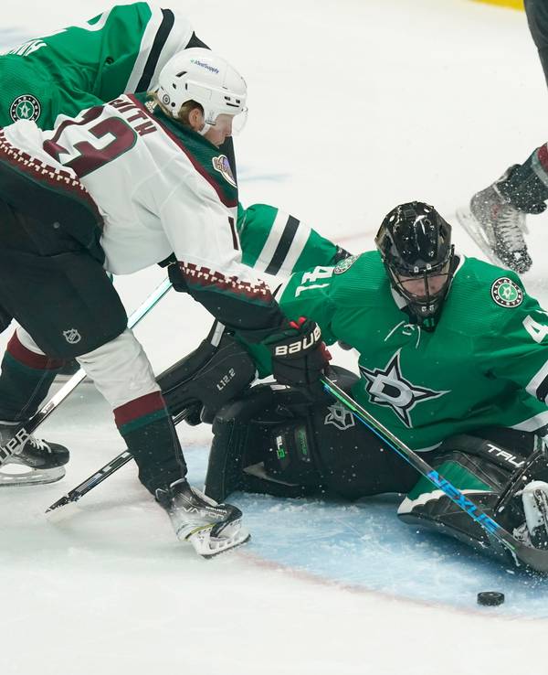 Arizona Coyotes center Nathan Smith (13) tries to score against Dallas Stars goaltender Scott Wedgewood (41) and defenseman Jani Hakanpaa (2) during the first period of an NHL hockey game in Dallas, Wednesday, April 27, 2022. (AP Photo/LM Otero)