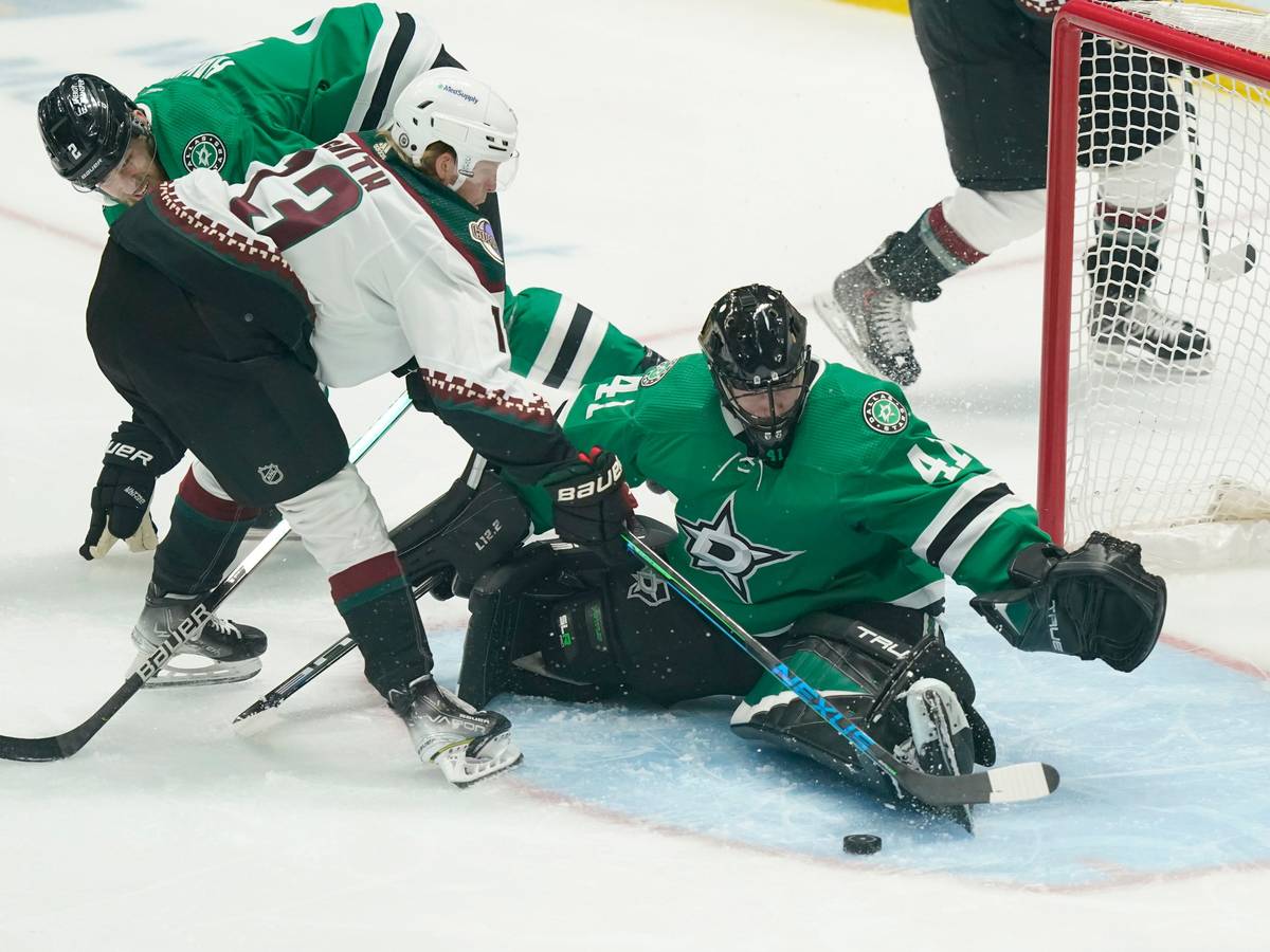 Arizona Coyotes center Nathan Smith (13) tries to score against Dallas Stars goaltender Scott Wedgewood (41) and defenseman Jani Hakanpaa (2) during the first period of an NHL hockey game in Dallas, Wednesday, April 27, 2022. (AP Photo/LM Otero)