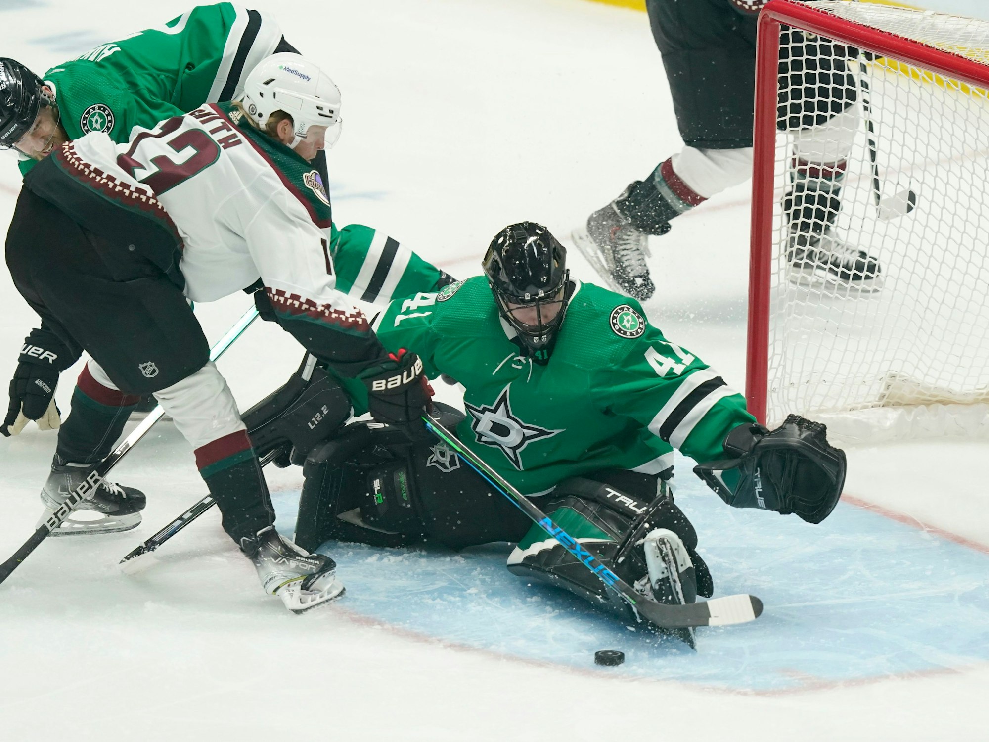 Arizona Coyotes center Nathan Smith (13) tries to score against Dallas Stars goaltender Scott Wedgewood (41) and defenseman Jani Hakanpaa (2) during the first period of an NHL hockey game in Dallas, Wednesday, April 27, 2022. (AP Photo/LM Otero)