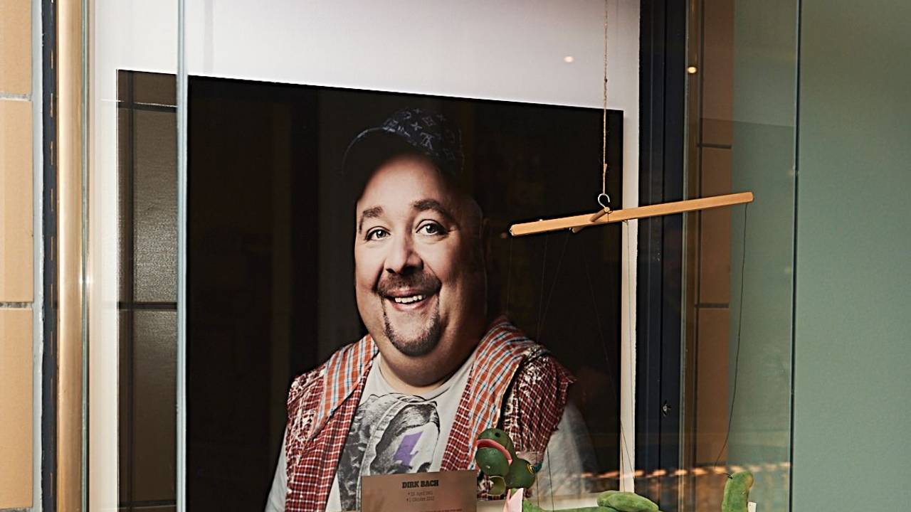 Die Vitrine im neuen Café Bach, in der ein Foto und verschiedene Erinnerungsstücke an den verstorbenen Dirk Bach zu sehen sind.