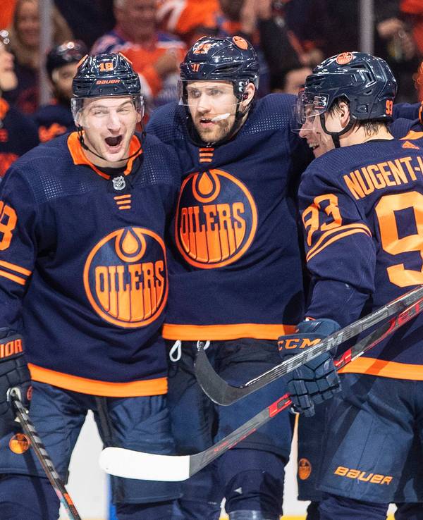 Edmonton Oilers' Zach Hyman (18), Leon Draisaitl (29) and Ryan Nugent-Hopkins (93) celebrate a goal against the Los Angeles Kings during the second period of Game 2 of an NHL hockey Stanley Cup playoffs first-round series Wednesday, May 4, 2022, in Edmonton, Alberta. (Jason Franson/The Canadian Press via AP)