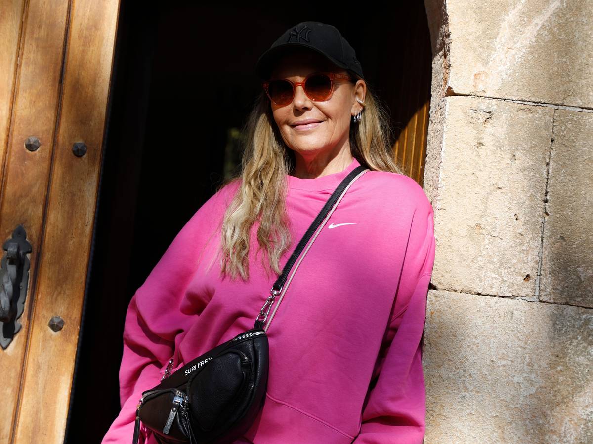 Natascha Ochsenknecht steht am 25. November 2021 in der Tür eines Hauses auf Mallorca in einem knallpinken Oberteil und trägt eine Sonnenbrille und eine schwarze Cap.