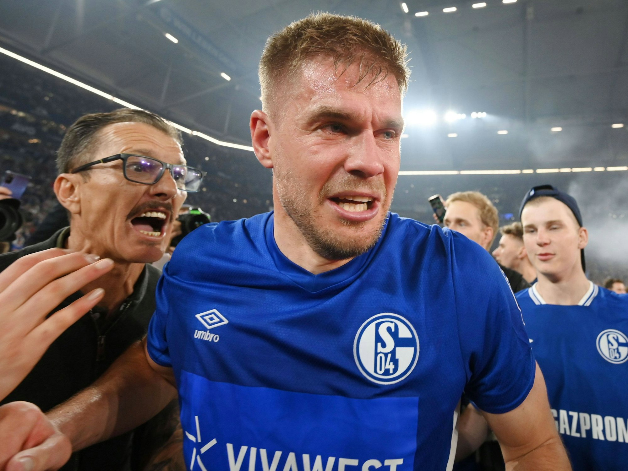 Die Schalker Fans stürmen nach dem Abpfiff den Platz und feiern Simon Terodde.