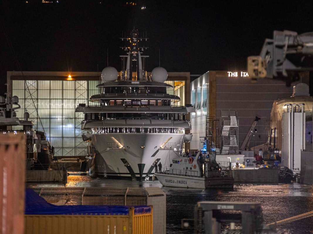 Ein Boot der italienischen Finanzpolizei ist vor der mehrere Millionen Dollar teuren Megayacht Scheherazade zu sehen, die am 6. Mai 2022 im toskanischen Hafen von Marina di Carrara, Toskana, angedockt ist, nachdem ihr Becken wieder geflutet wurde.