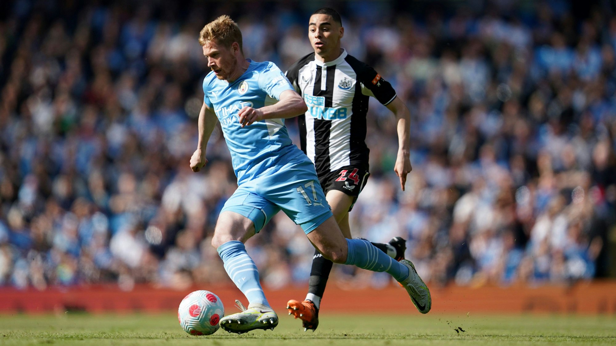 Fußball: Premier League, England, Manchester City – Newcastle United, 36. Spieltag im Etihad Stadium: Kevin De Bruyne (l) von Manchester City gegen Miguel Almiron von Newcastle United.