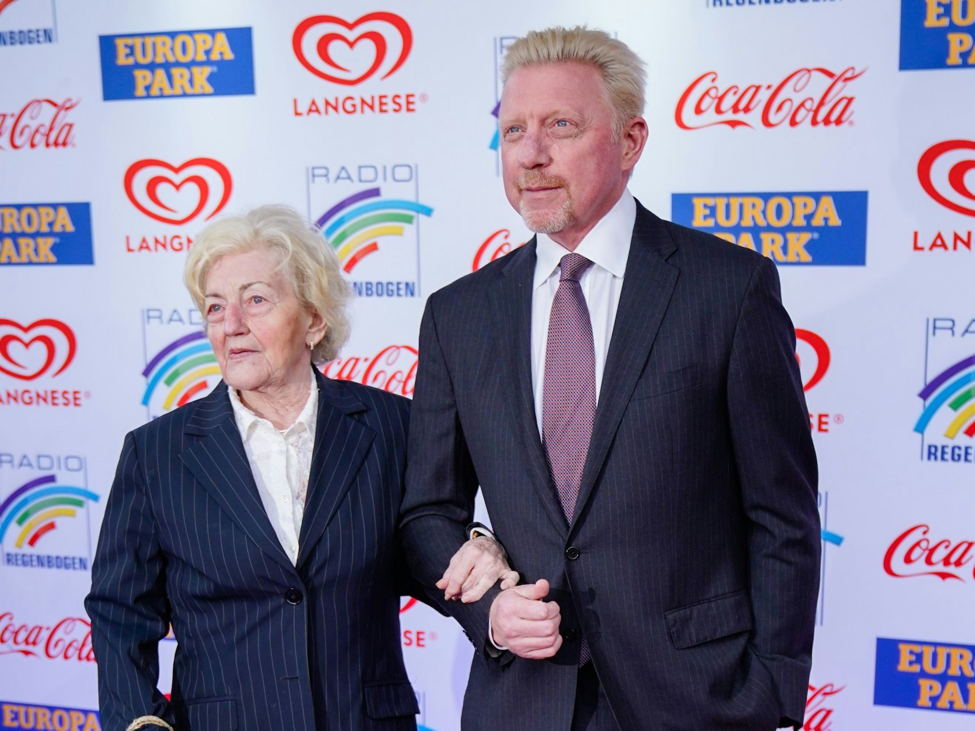 Boris Becker und seine Mutter Elvira Becker halten Händchen.