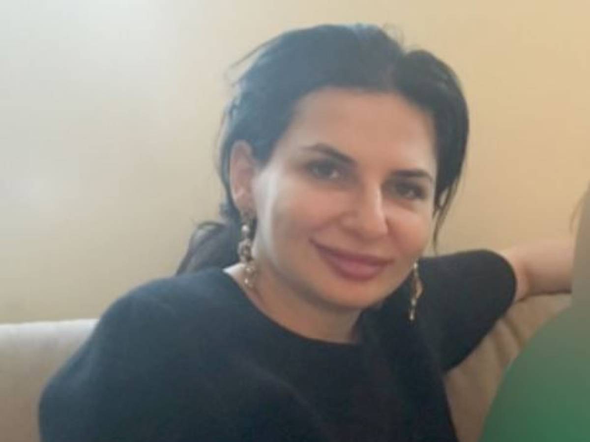 Dr. Ruja Ignatova sitzt auf einem Sessel und lacht in die Kamera.