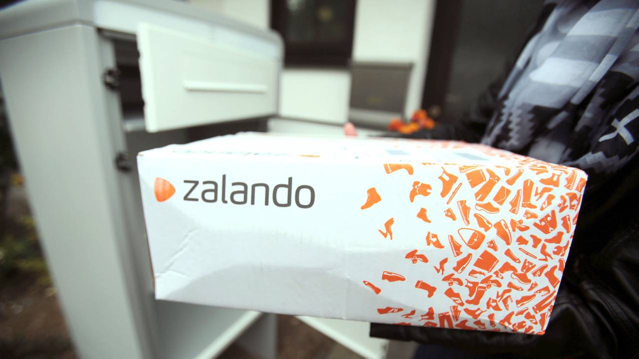 Eine Frau hält in Königswinter (Nordrhein-Westfalen) ein Paket des Online-Versandhändlers für Schuhe und Mode, Zalando.