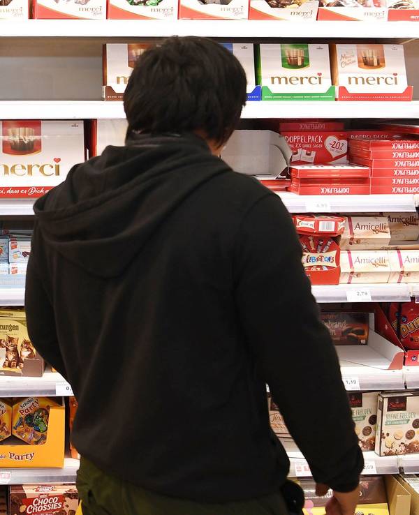 Der beliebte Schoko-Snack wird zurückgerufen. Unser Foto zeigt einen Kunden vor einem Süßigkeiten-Regal.