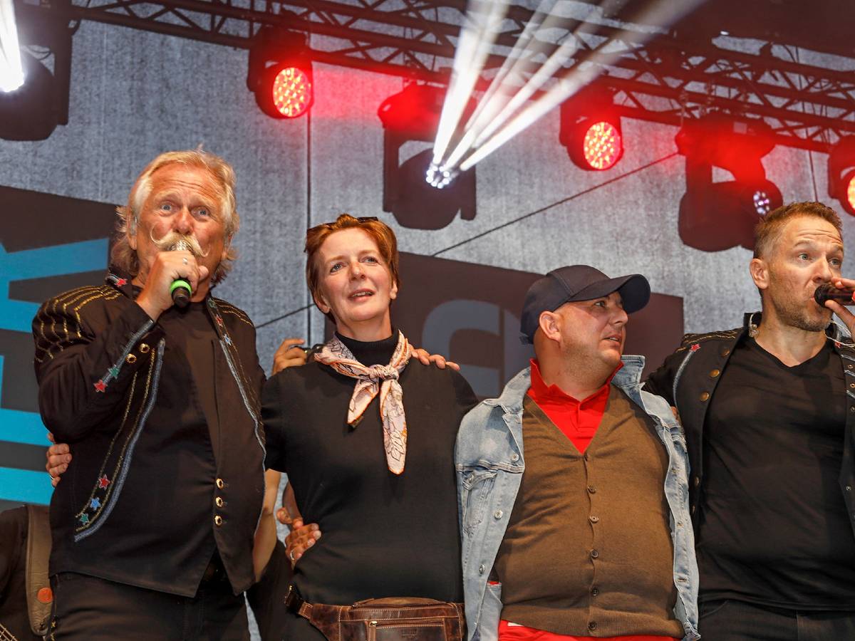 Henning Krautmacher und Patrick Lück von den Höhnern stehen mit Anke und Michael aus Duisburg auf der Bühne.