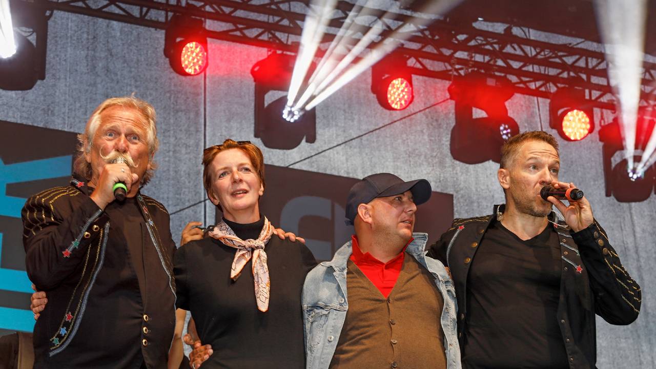 Henning Krautmacher und Patrick Lück von den Höhnern stehen mit Anke und Michael aus Duisburg auf der Bühne.