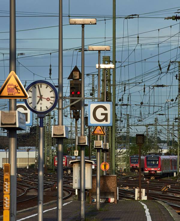 Regionalzüge stehen im Hauptbahnhof in Dortmund auf Abstellgleisen. Zu sehen sind unter anderem auch Oberleitungen und Warnschilder, die vor dem Betreten der Bahnanlage warnen.