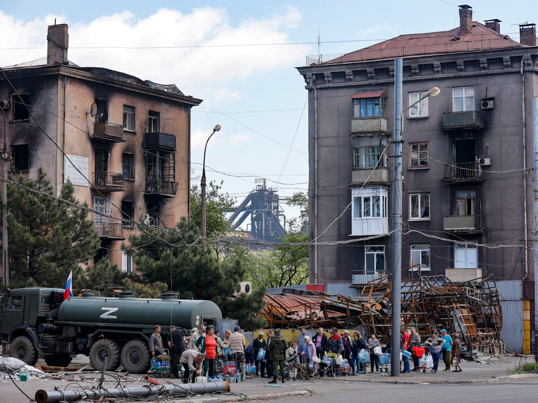 Einheimische versammeln sich, um Trinkwasser zu erhalten, das vom russischen Ministerium für Notsituationen in Mariupol in der Ukraine verteilt wurde.