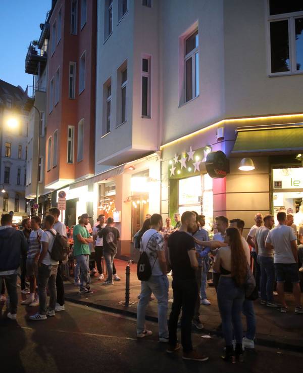 Menschen stehen Schlange an einem Kiosk an der Brüsseler Straße.