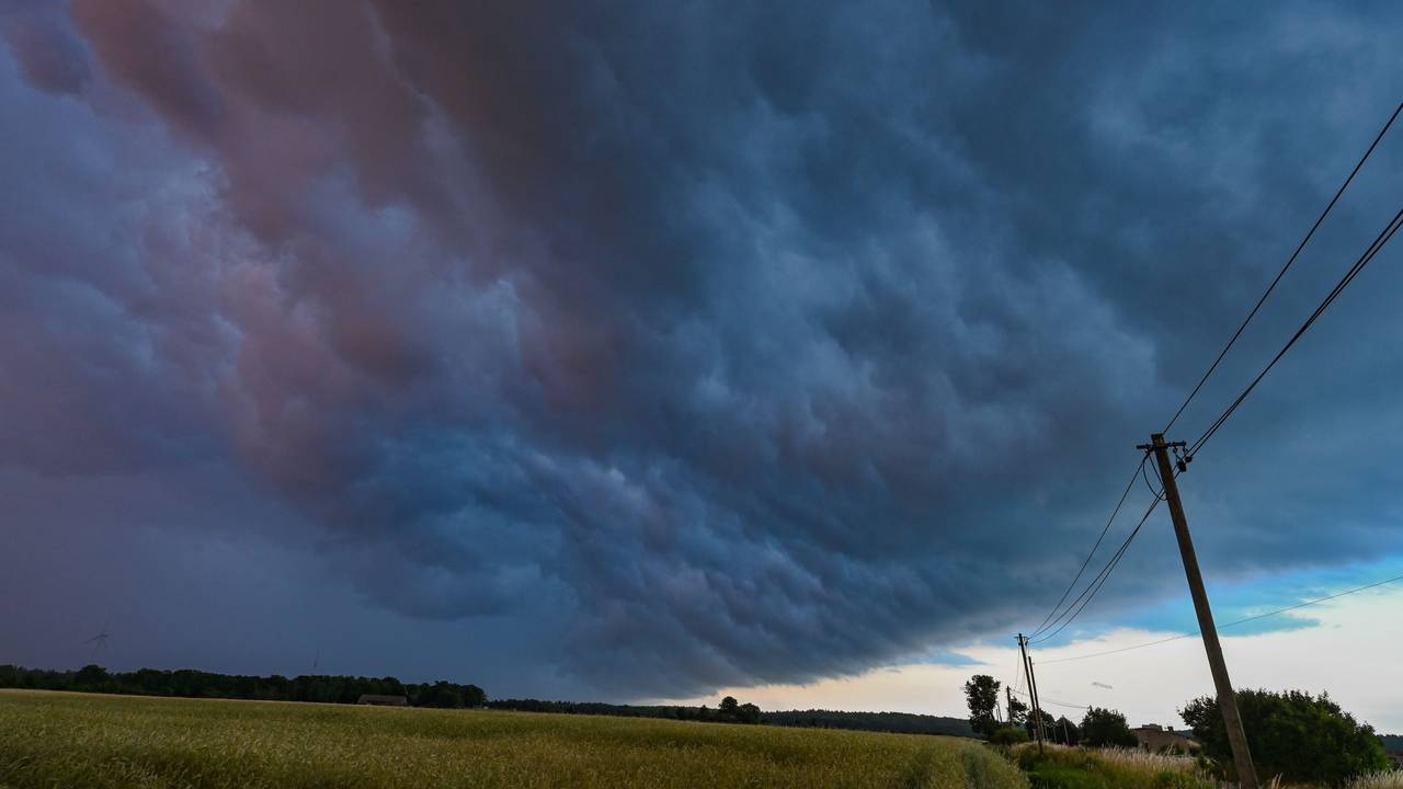 Am späten Abend zieht eine Gewitterzelle mit dunklen Regenwolken über die Landschaft.