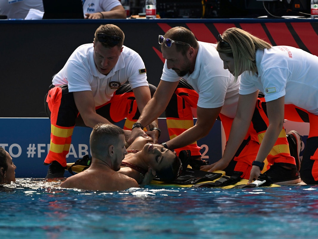 Anita Alvarez wird nach ihrer Rettung im Wasser bei der Schwimm-WM in Budapest von Sanitäterinnen und Sanitätern am Beckenrand in Empfang genommen.