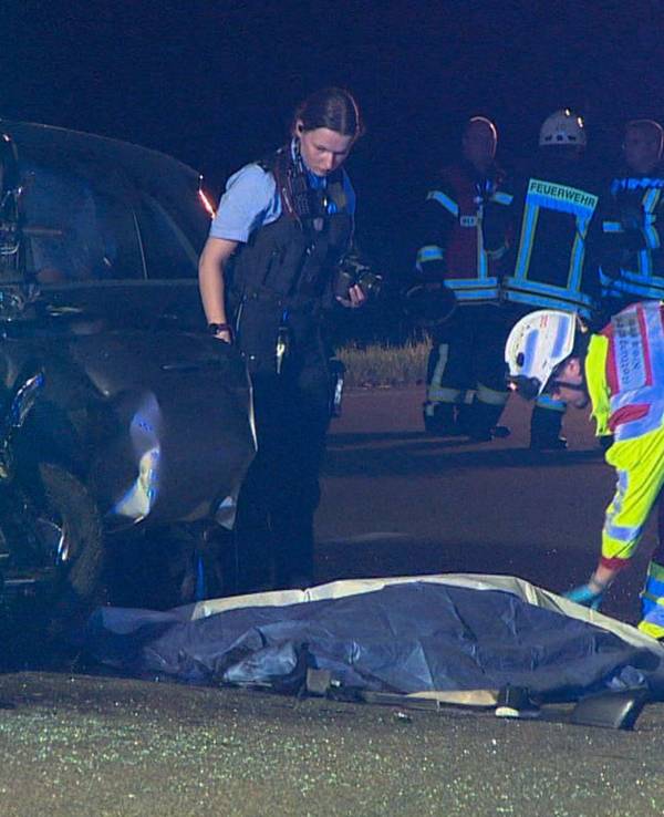 Polizei und Rettungskräfte kümmern sich an einer Unfallstelle um geborgene Leichen.