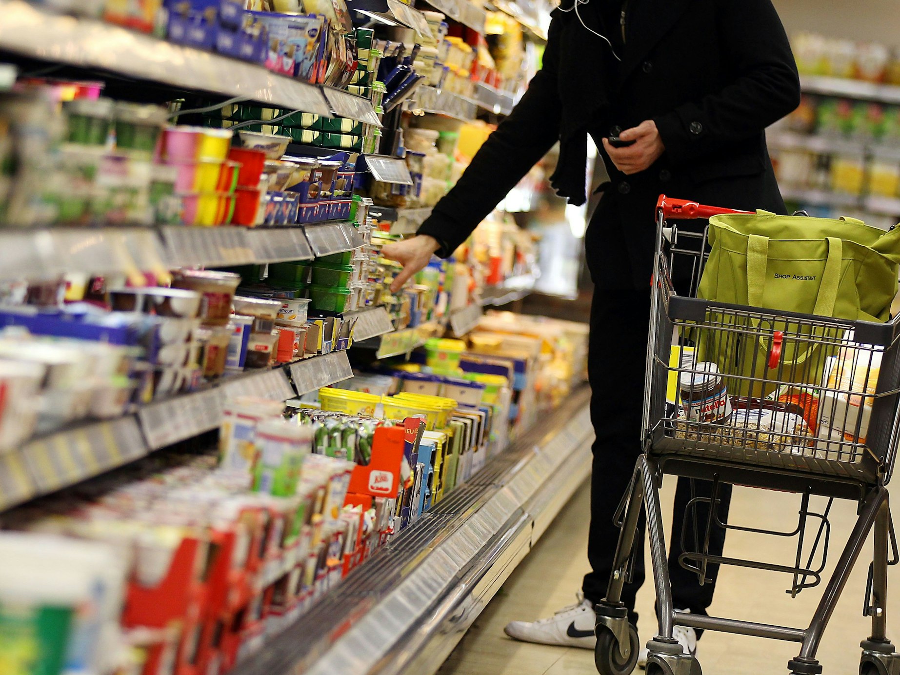 Der Preis für einen Liter Milch durchbricht bei Aldi eine historische Marke. Unser Symbolfoto zeigt einen Kunden an einem Kühlregal.