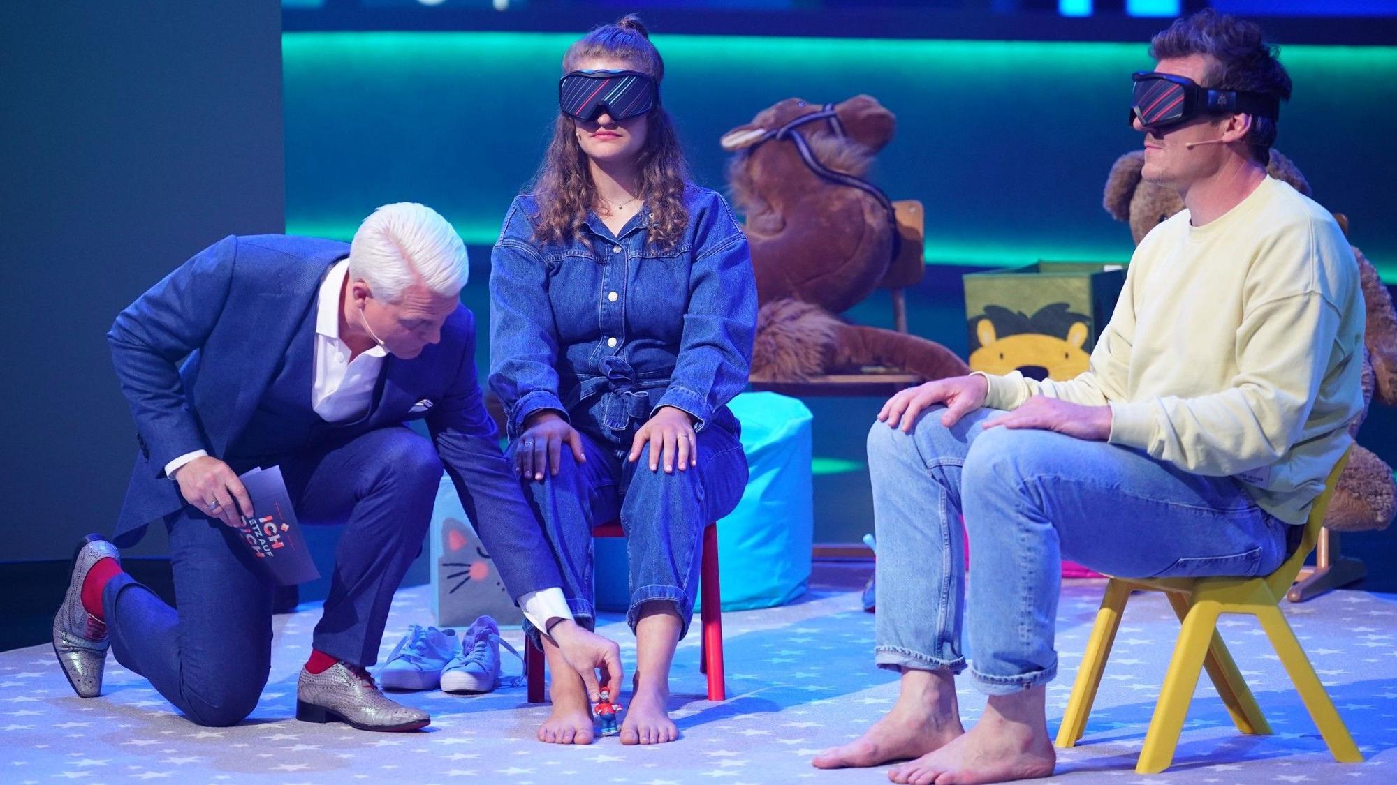 Moderator Guido Cantz (l.) und das Kandidaten-Ehepaar Jennifer und Jan Wand während der Tonie-Wette.