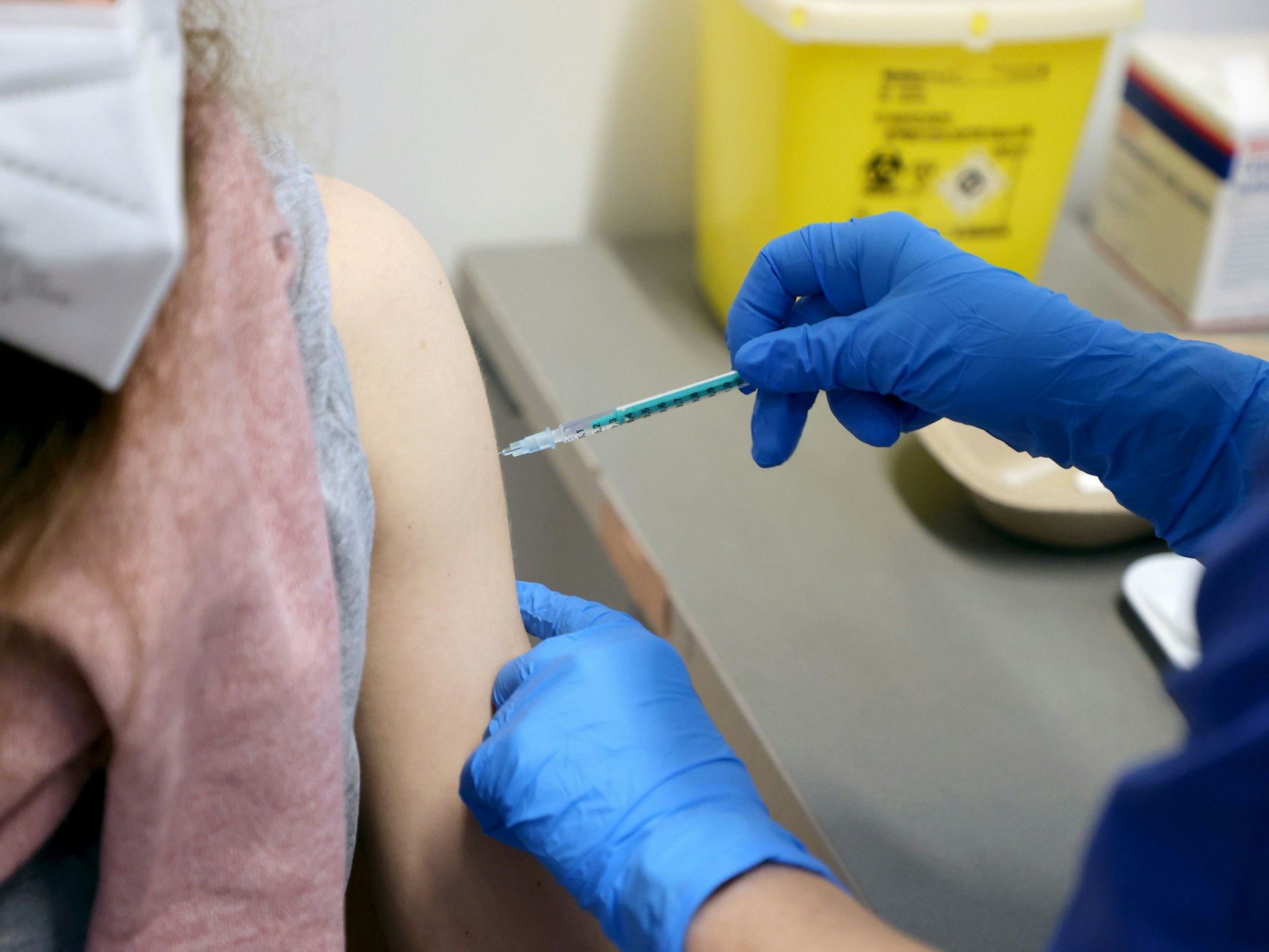 Eine Frau erhält eine Impfung in den Oberarm.