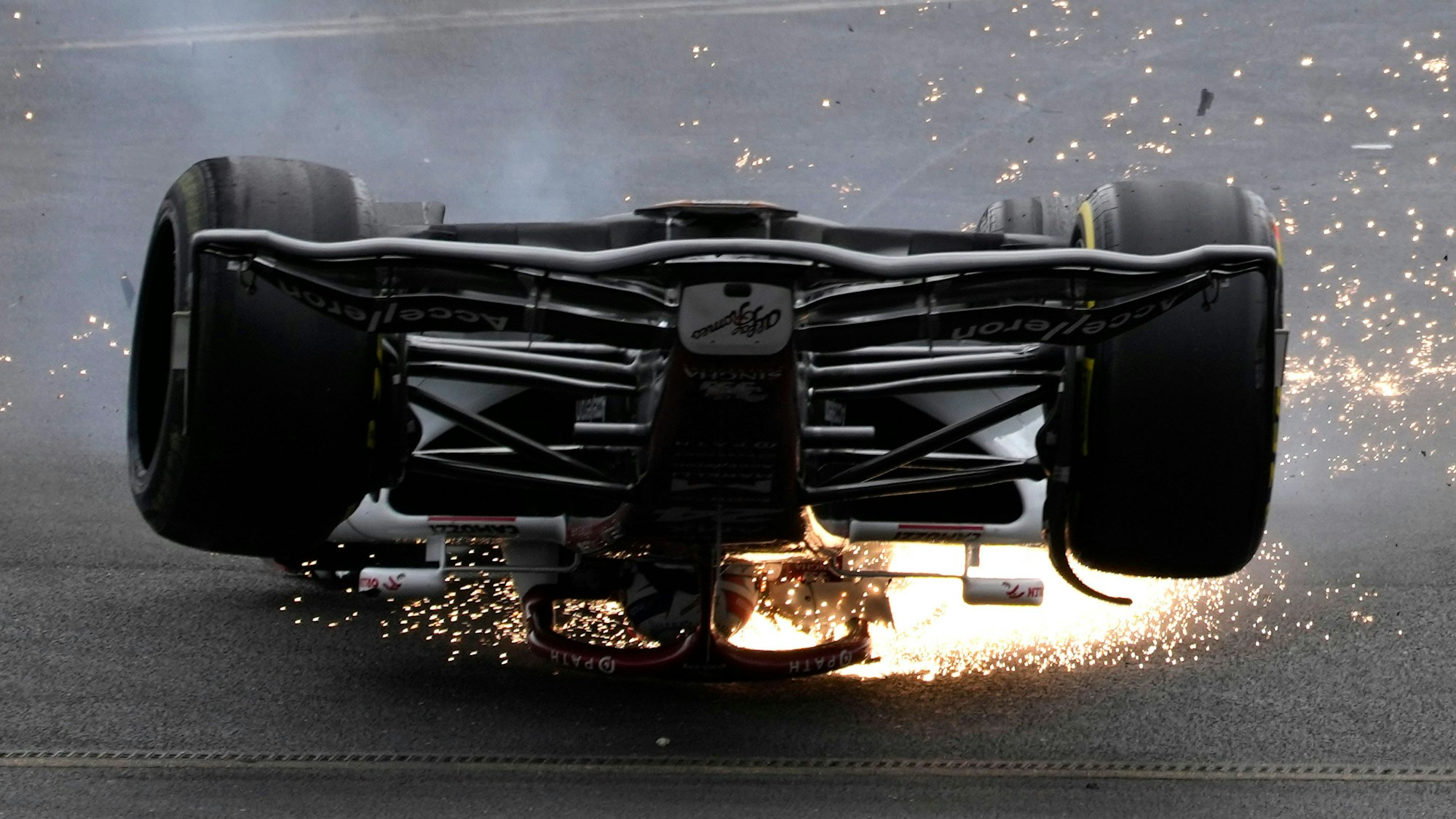 Alfa Romeo driver Guanyu Zhou of China crashes at the start of the British Formula One Grand Prix at the Silverstone circuit, in Silverstone, England, Sunday, July 3, 2022. (AP Photo/Frank Augstein)