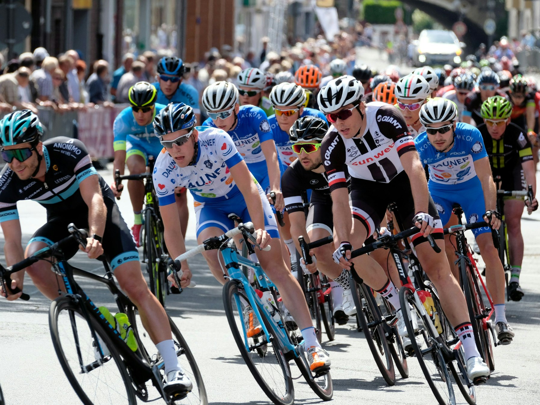Das Fahrerfeld beim Hauptrennen der Cologne Classics biegt in eine Kurve.