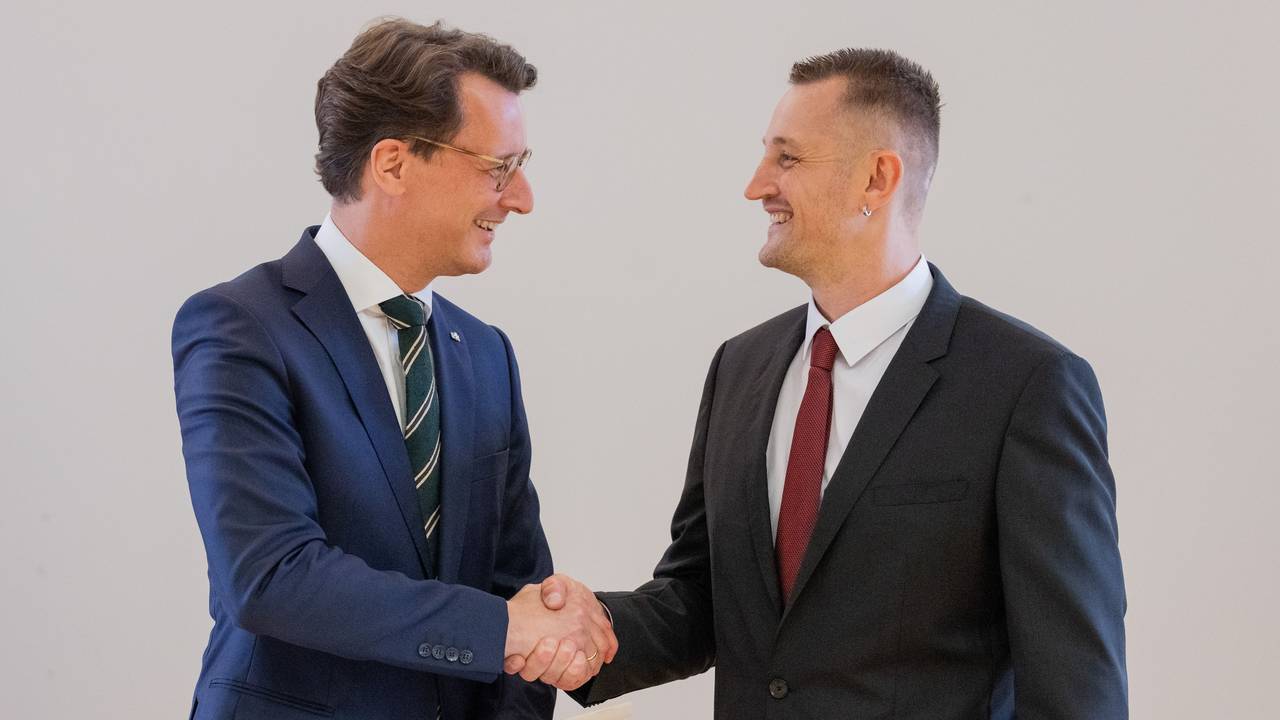 Hendrik Wüst (l, CDU), Ministerpräsident von Nordrhein-Westfalen, überreicht dem Lebensretter Dustin Raatz die Rettungsmedaille des Landes Nordrhein-Westfalen.