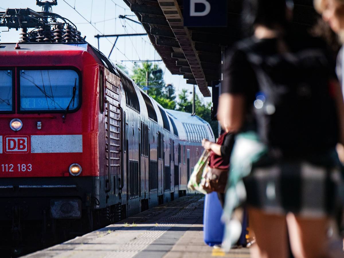 Fahrgäste warten im Bahnhof auf eine Regionalbahn.