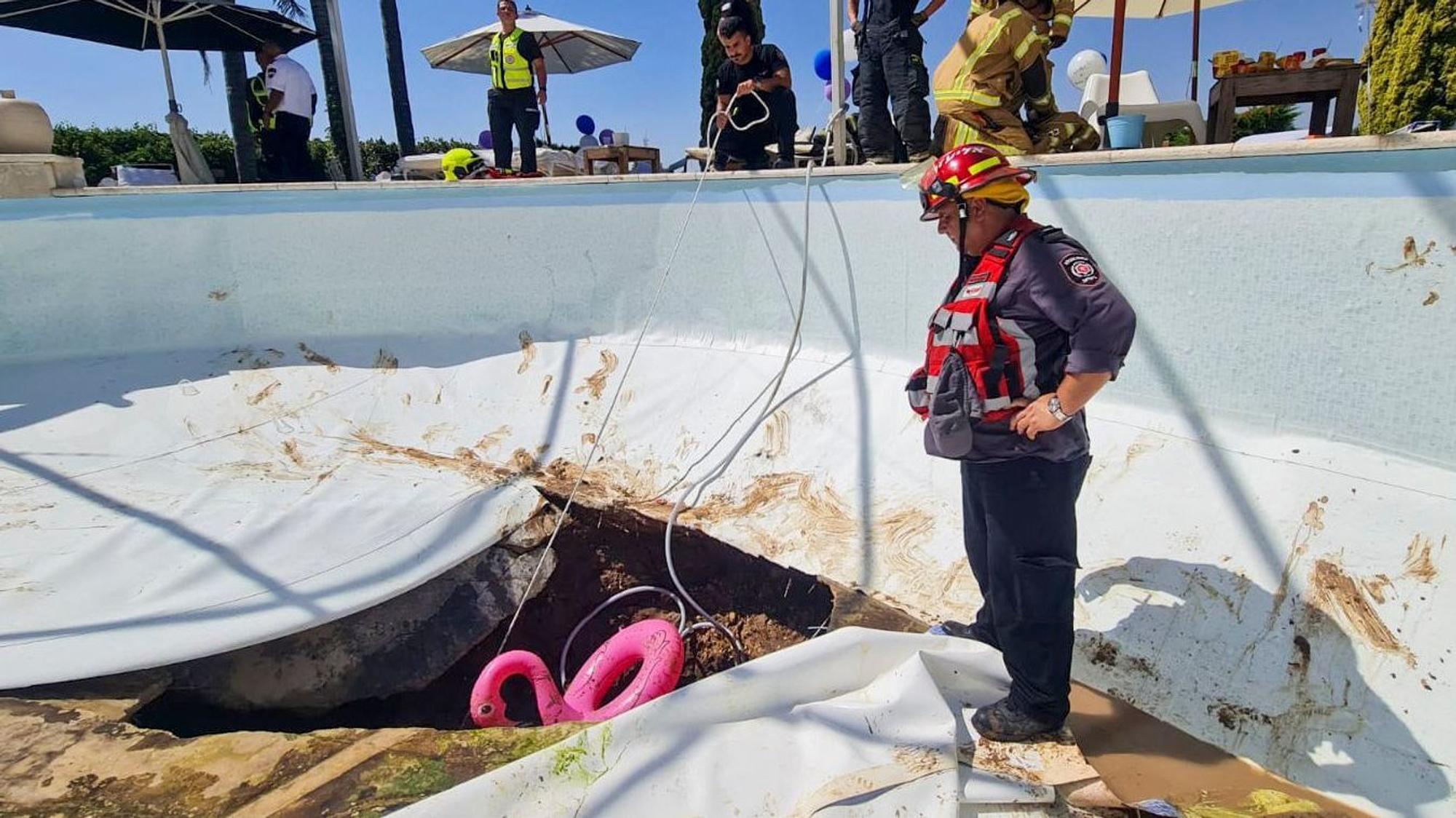 Einsatzkräfte stehen um das Loch im Pool in Israel.