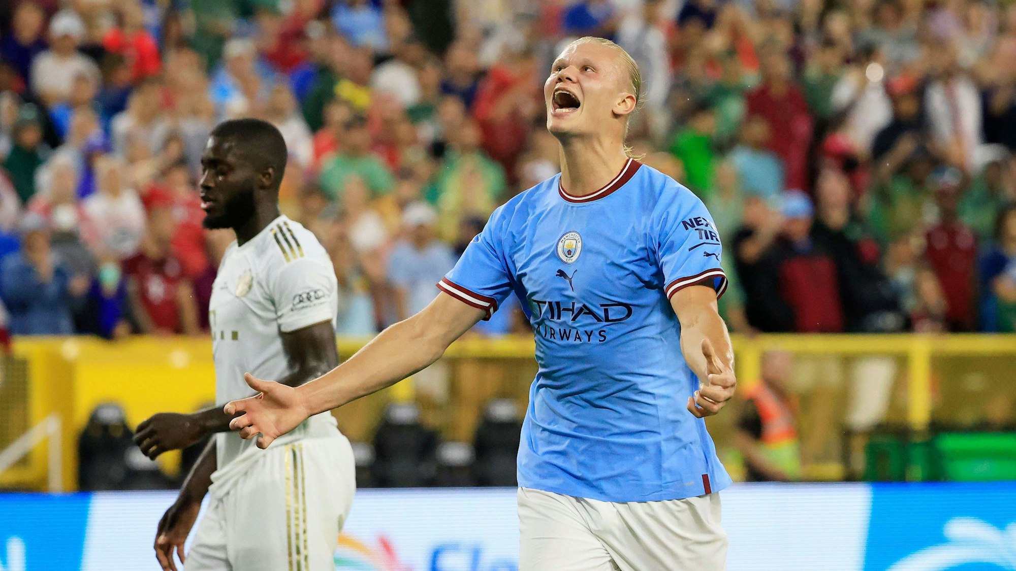 City-Star Erling Haaland jubelt nach seinem Treffer, im Hintergrund steht Bayern-Profi Dayot Upamecano.