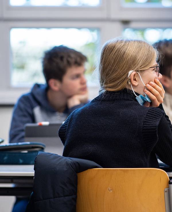 In der 9. Klasse der Gesamtschule in Münster hat eine Schülerin ihre Maske unter das Kinn gezogen.