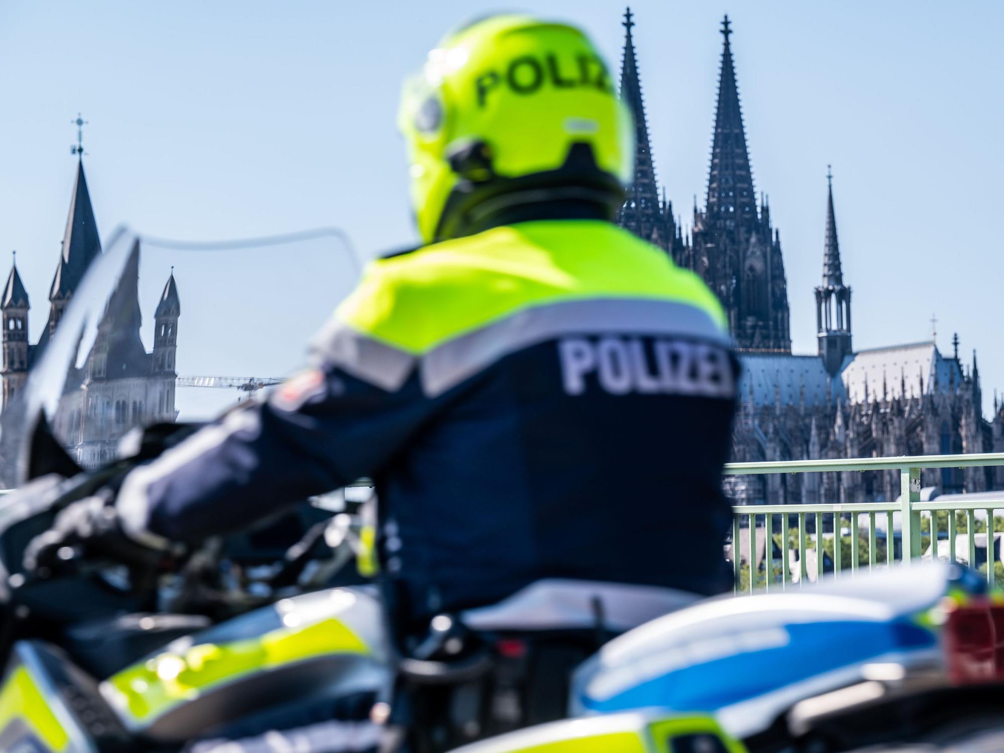 Ein Polizist fährt mit dem Motorrad über die Deutzer Brücke.