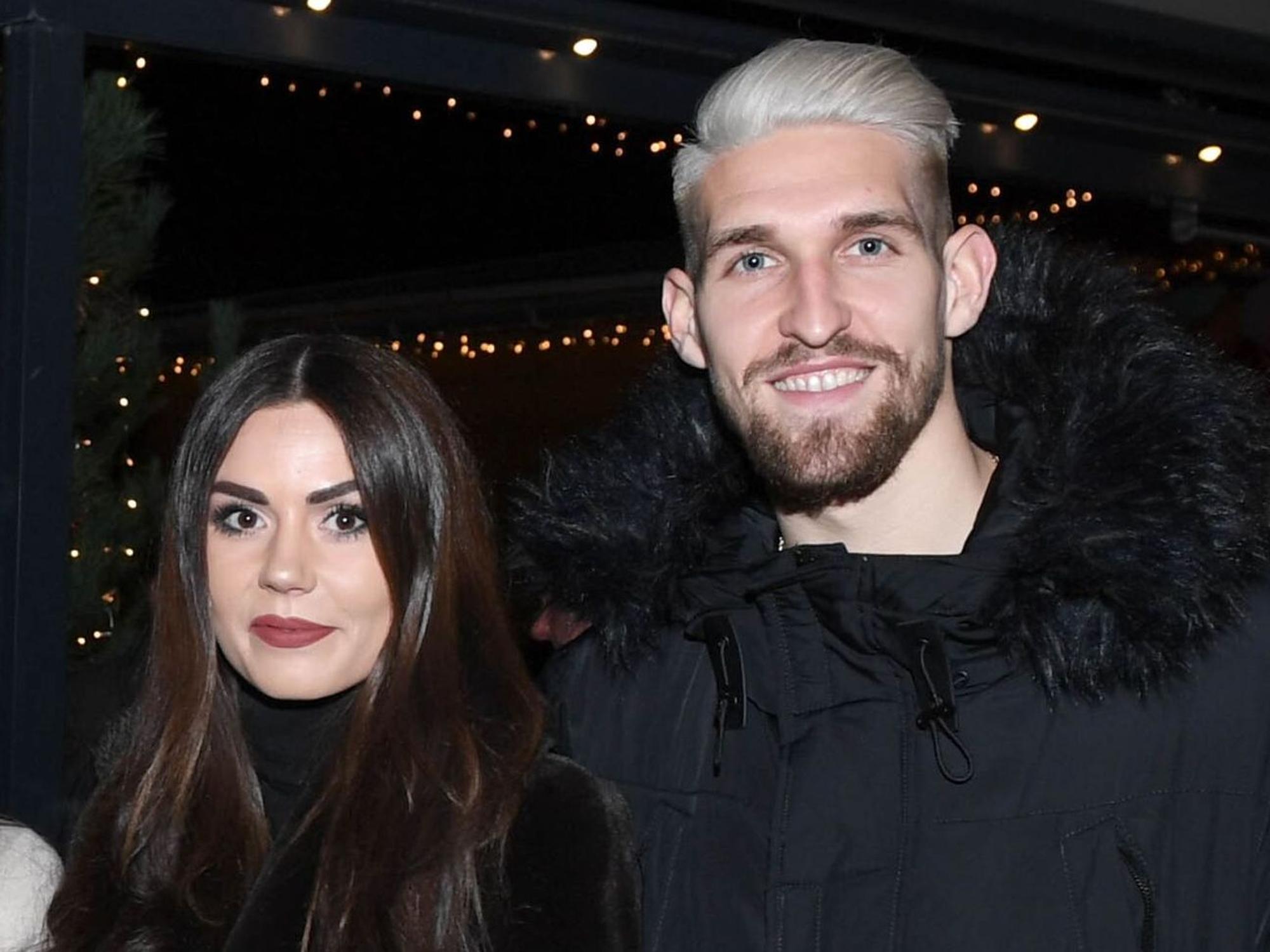 Fußballer Robert Andrich posiert neben seiner Frau Alicia Andrich.