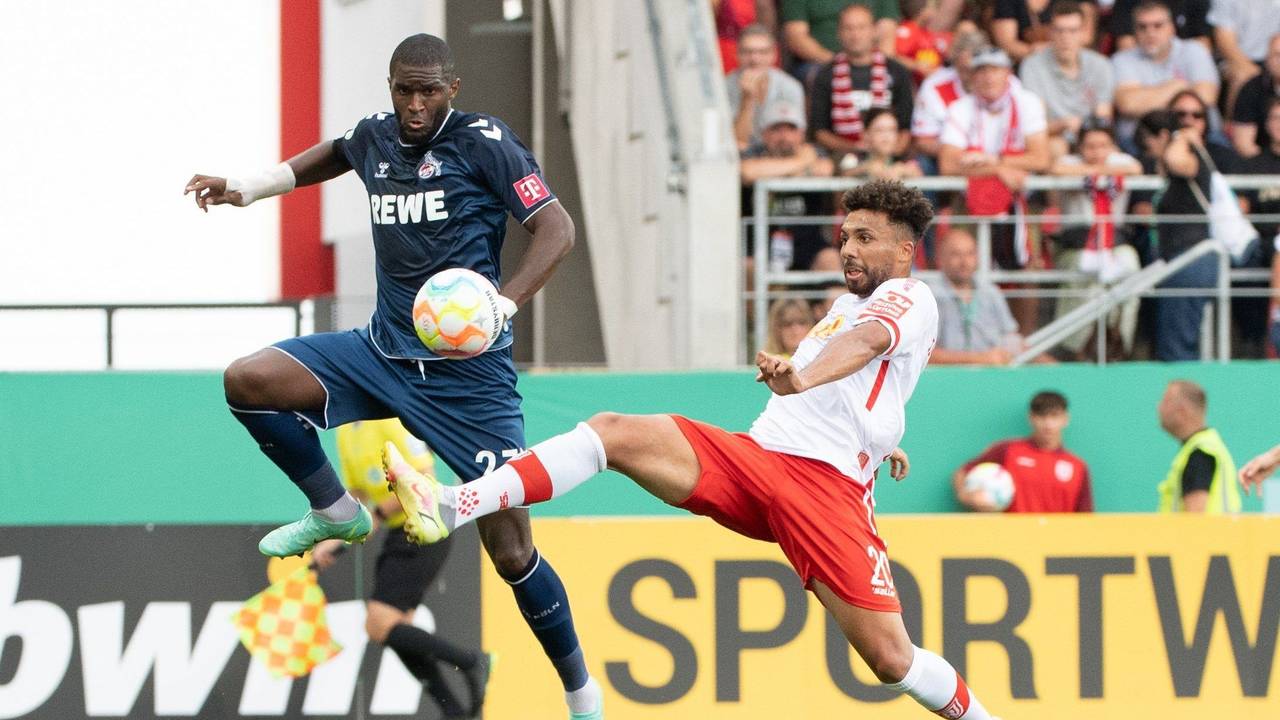 Anthony Modeste (l) vom 1. FC Köln und Leon Guwara vom SSV Jahn Regensburg im Zweikampf um den Ball.