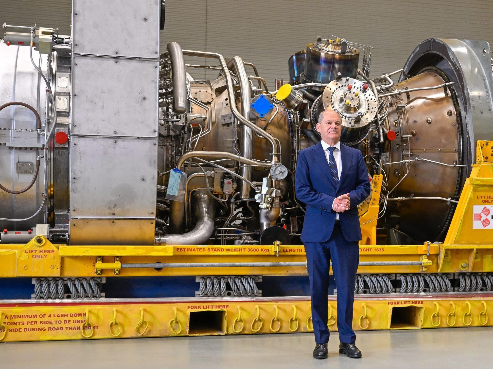 Bundeskanzler Olaf Scholz (SPD) steht am Mittwoch (3. August) vor der in Kanada für die Erdgas-Pipeline Nordstream 1 gewarteten Turbine in Mülheim an der Ruhr. Der Kreml reagierte sofort.