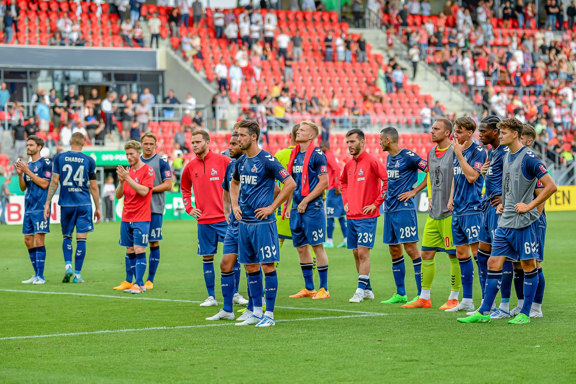 Enttäuschte Spieler des 1. FC Köln stehen nach Schlusspfiff vor ihren Fans auf der Tribüne.