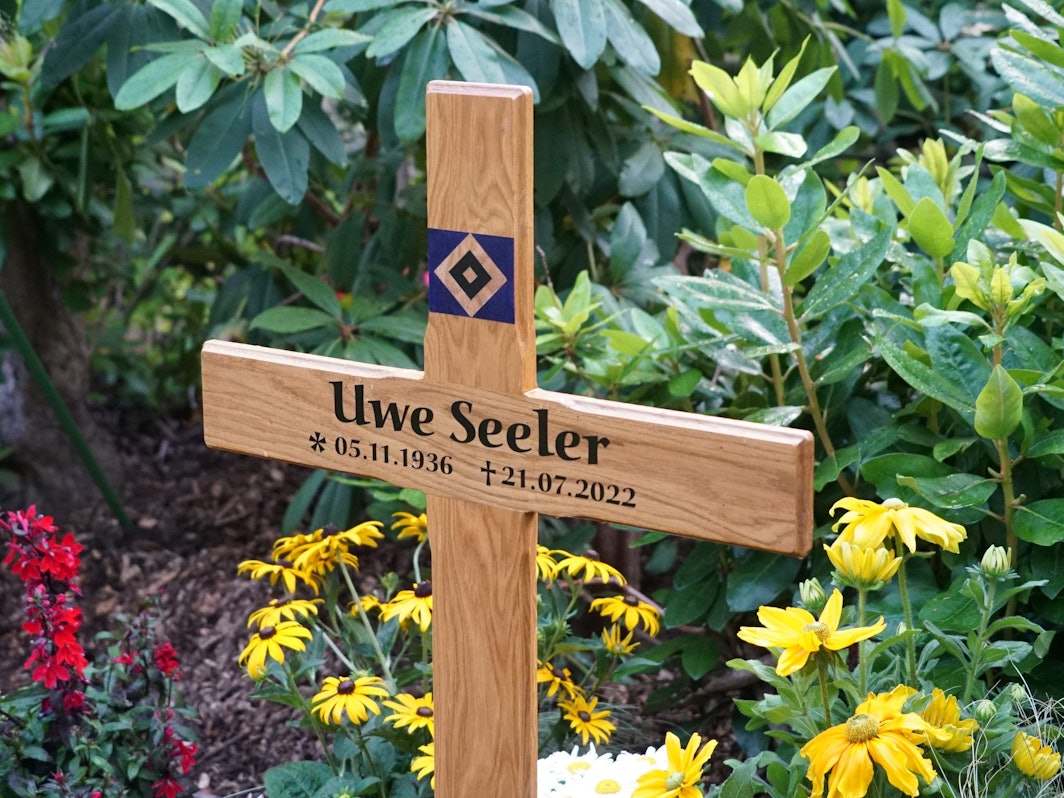 Ein Holzkreuz steht auf dem Grab der Fußballlegende Uwe Seeler. Der beliebte Sportler wurde im engsten Familienkreis auf dem Friedhof Ohlsdorf beigesetzt.