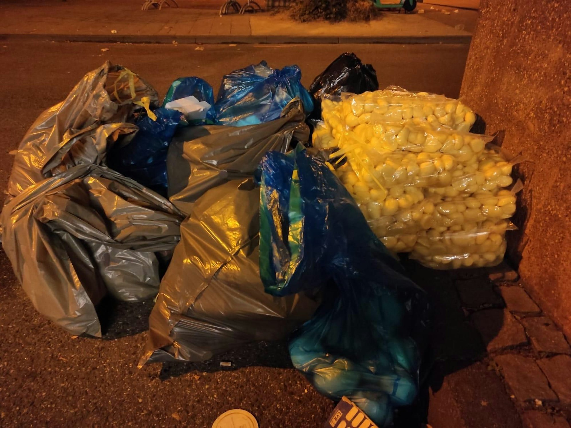 Kartoffeln liegen in Deutz auf vollen Müllsäcken.