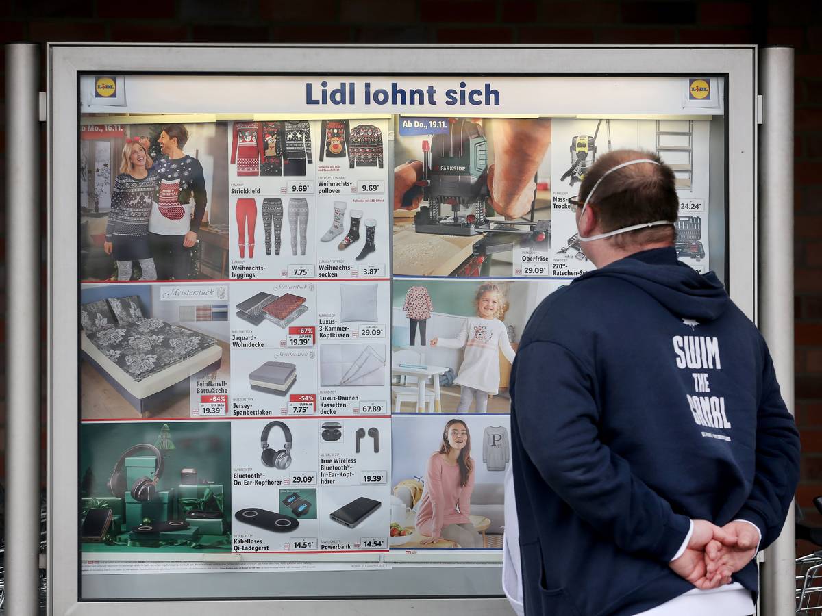 Der Kunde einer Lidl-Filiale informiert sich in unserem Archivbild (2020) an einer Werbetafel über die Sonderangebote. Wie Lidl mitteilt, will der Discounter das Angebot seiner Nonfood-Produkte einschränken.