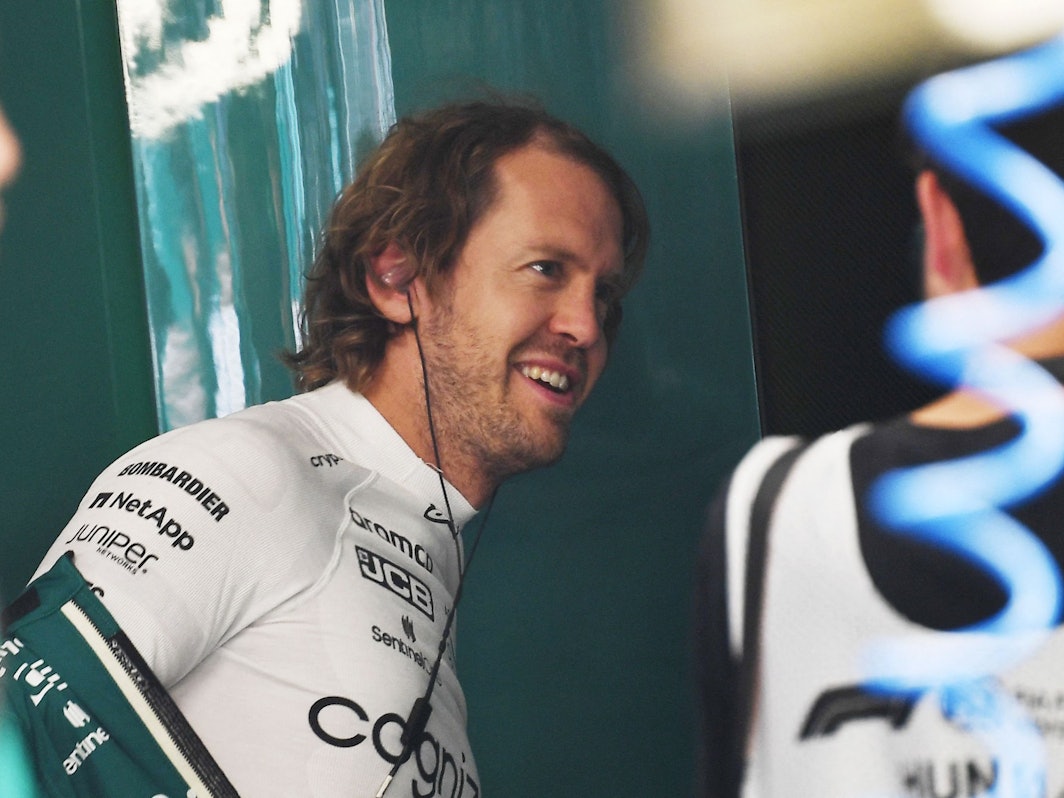 Sebastian Vettel lacht in der Box der Formel 1 im Fahrerlager der Formel 1.