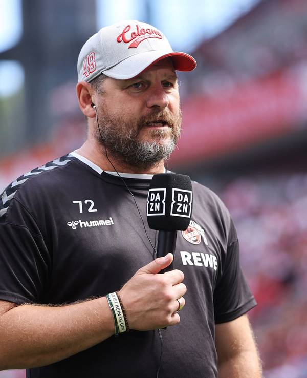 Steffen Baumgart steht am 28. August 2022 mit DAZN-Mikrofon im Stadion.