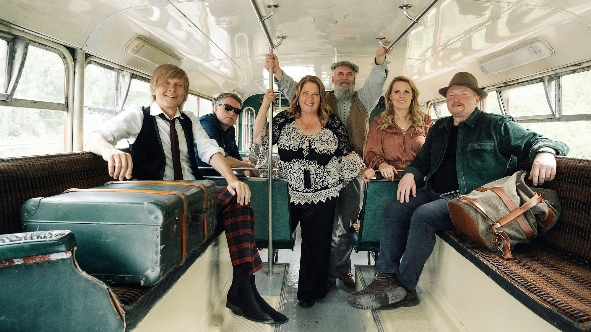 Die Kelly Family sitzt in ihrem Doppeldecker-Bus.