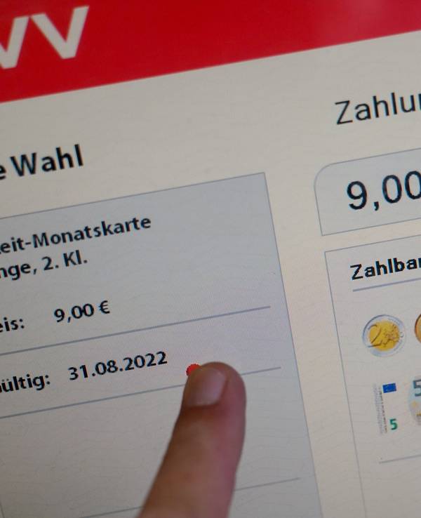 Ein Mann berührt den Touchscreen eines Fahrscheinautomaten für ein 9-Euro-Ticket im U-Bahnhof Landungsbrücken.
