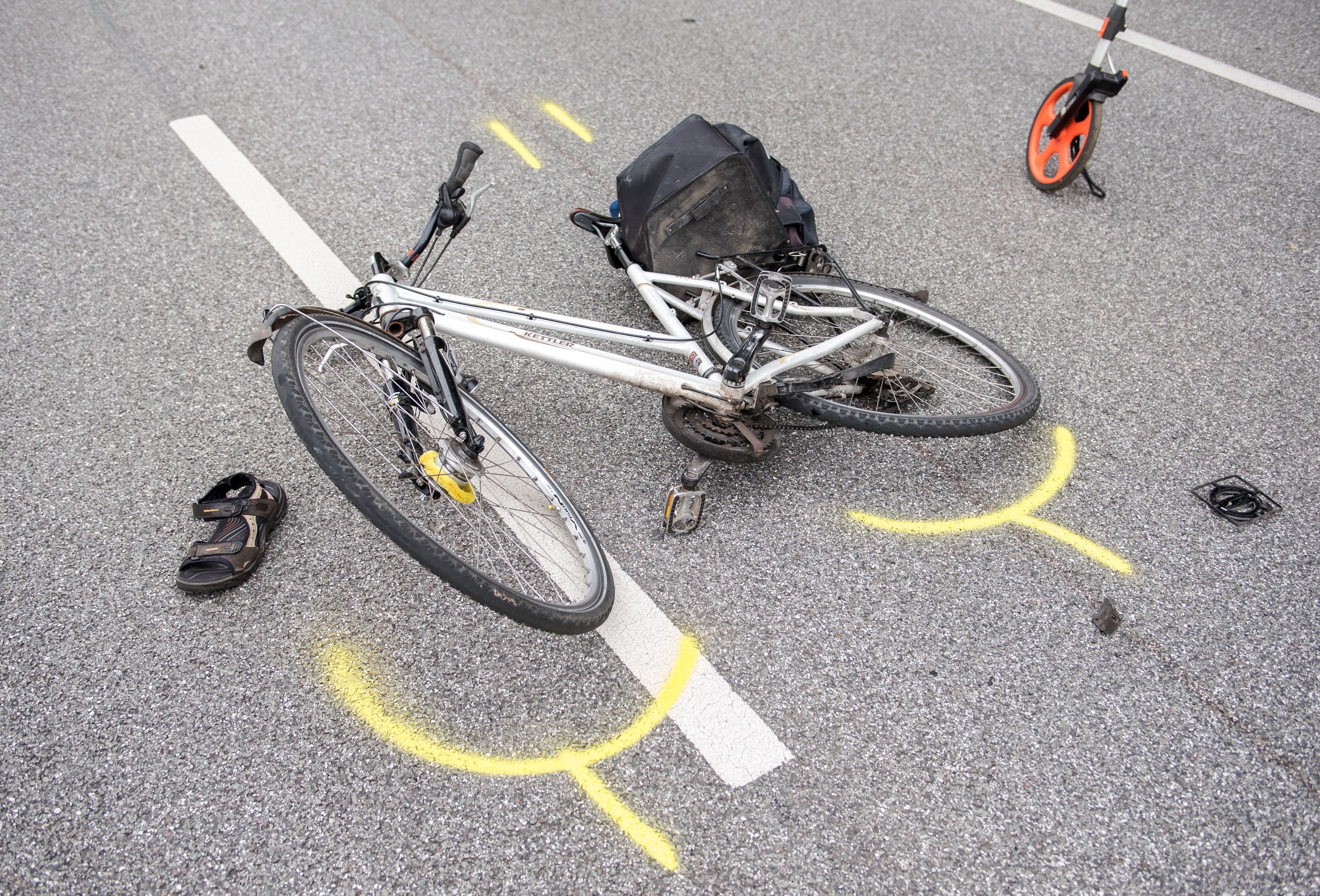 Auf einer Straße liegt ein Fahrrad.
